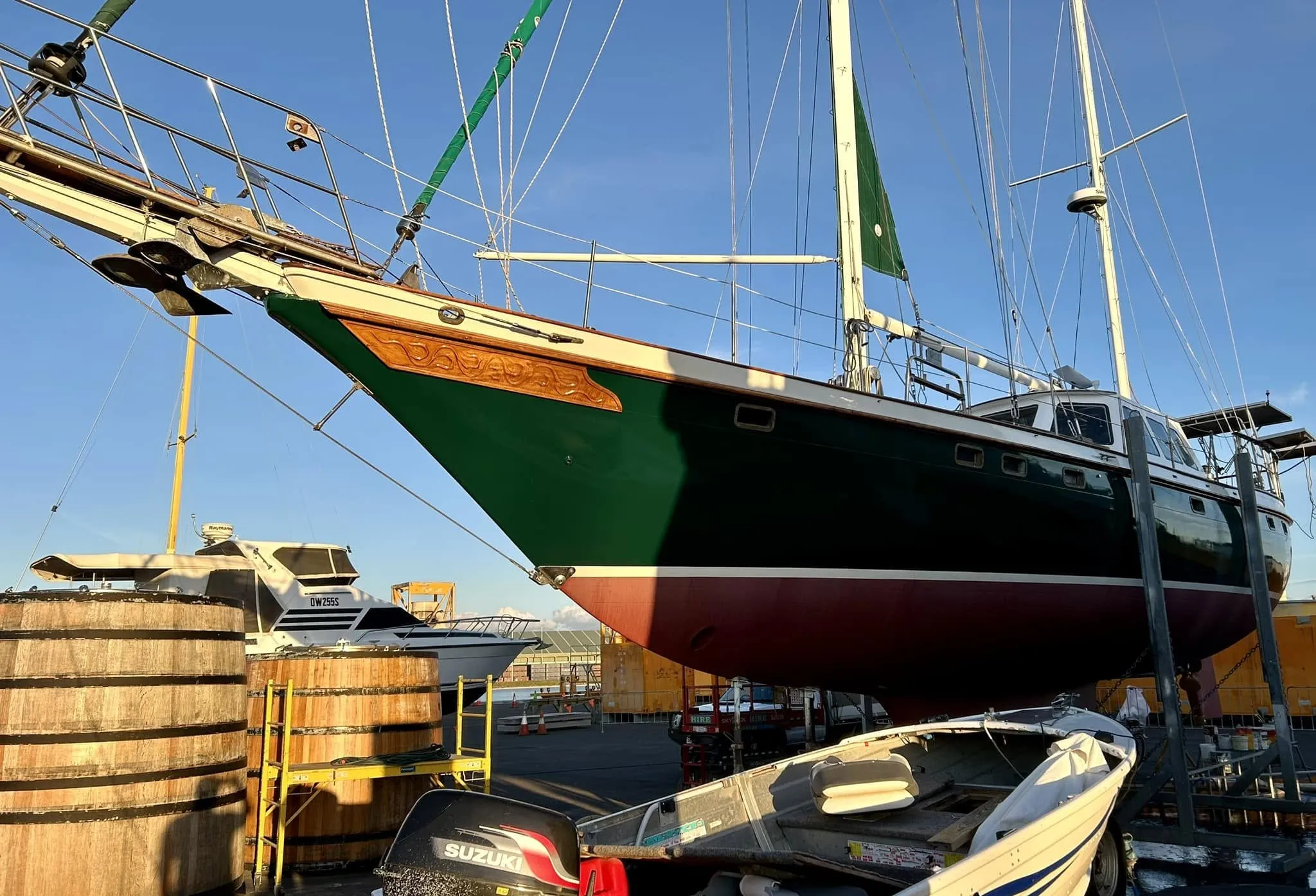 Sea Dragon on the hardstand in her new racing-green paint, beside two wine barrels