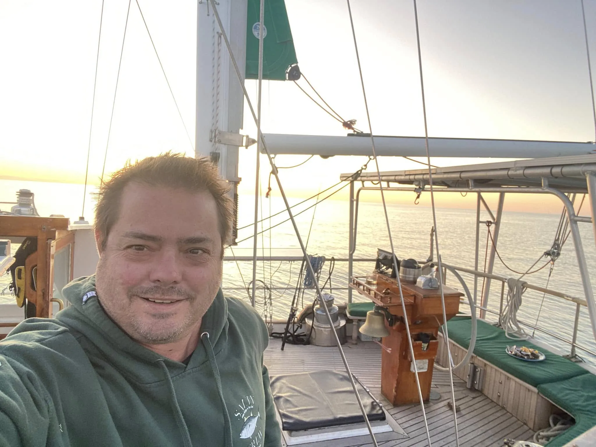 Tim smiling in Sea Dragon's cockpit at sunset
