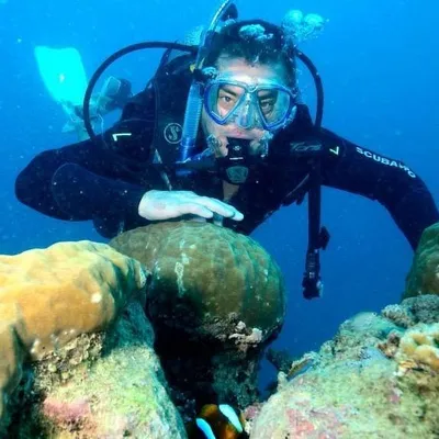 Tim scuba diving over coral