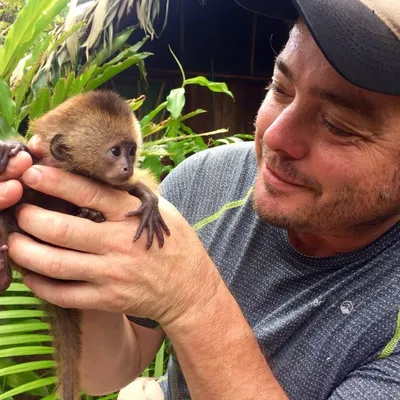 Tim holding a baby monkey