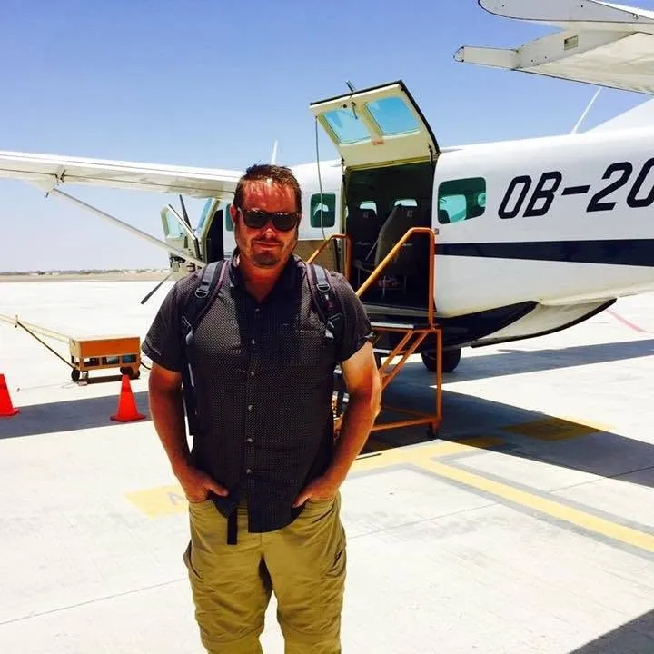 Tim standing in front of a light aircraft on an airport apron